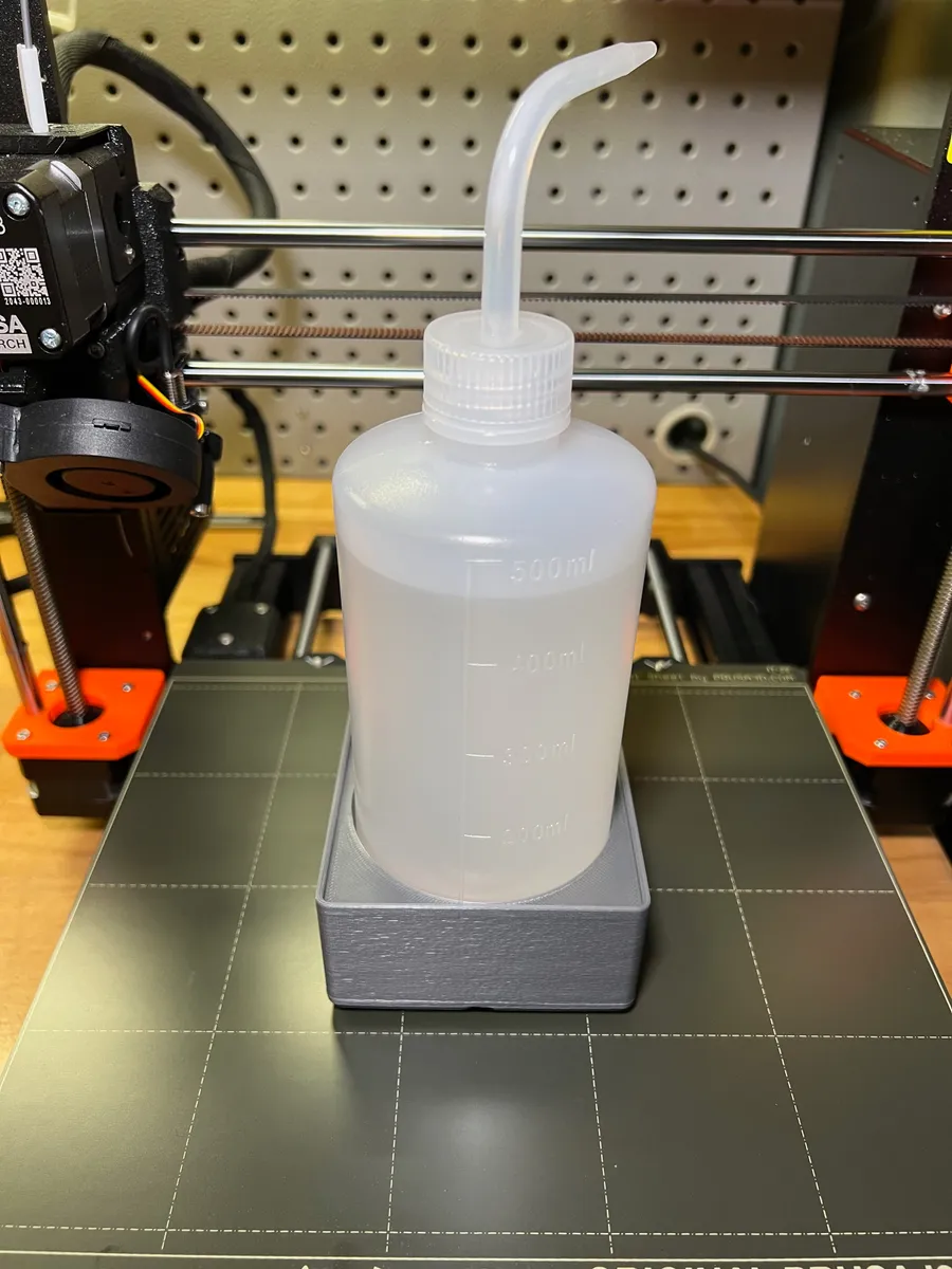 A wash bottle nested inside of a 3D printed gridfinity based wash bottle holder